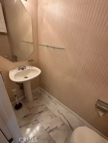 a bathroom with a sink toilet and mirror