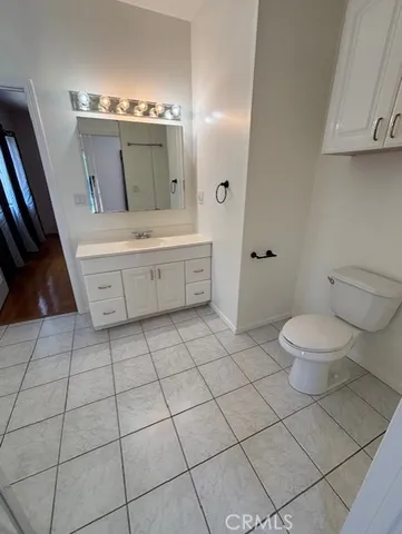 a large bathroom with a toilet a sink and a mirror
