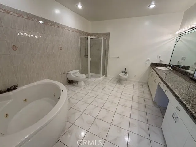a bathroom with a granite countertop sink a toilet and bathtub