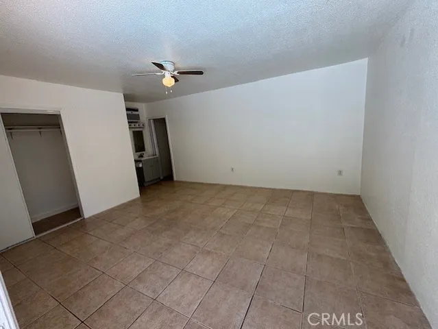 an empty room with a ceiling fan