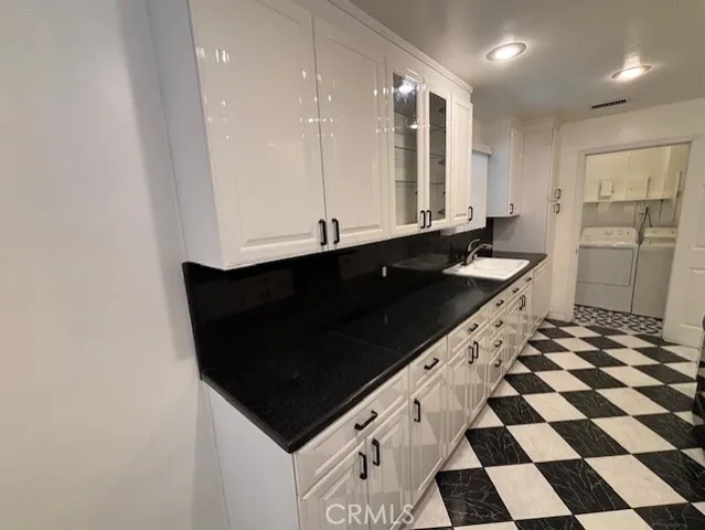 a kitchen with a sink and a refrigerator