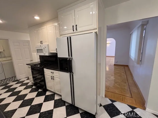 a kitchen with a refrigerator a sink and a stove