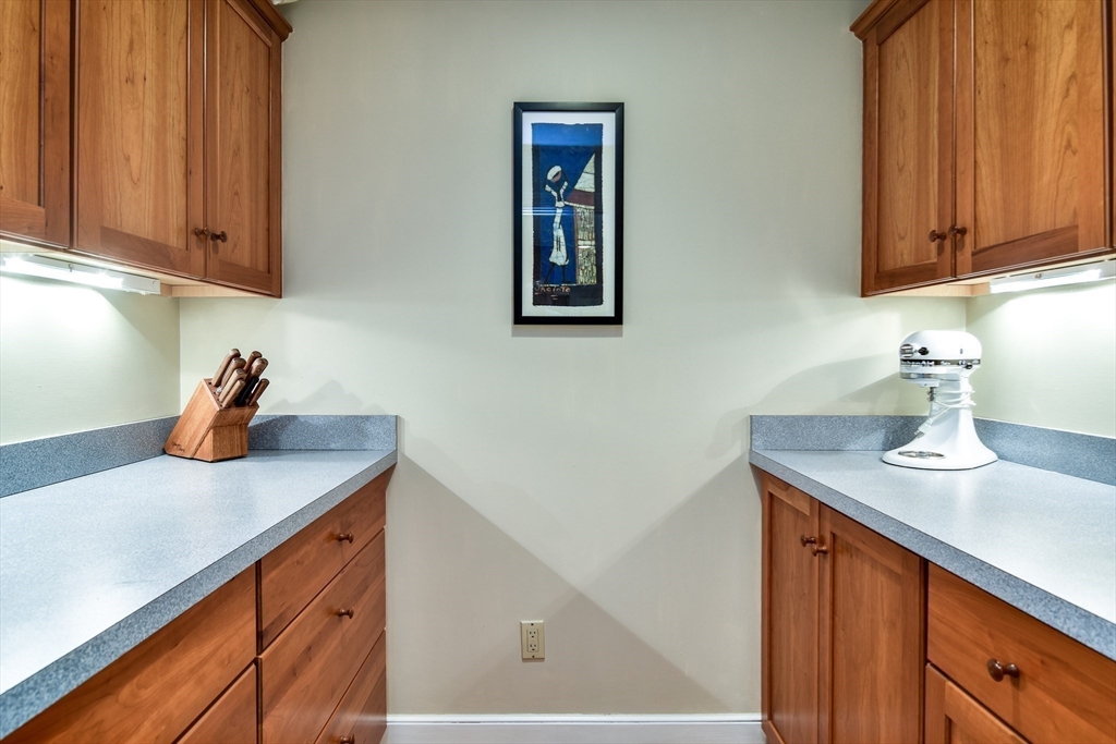 114 Hunters Ridge Road Concord, MA 01742 - Photo 15 of 38 a kitchen with stainless steel appliances granite countertop a sink dishwasher and cabinets with wooden floor