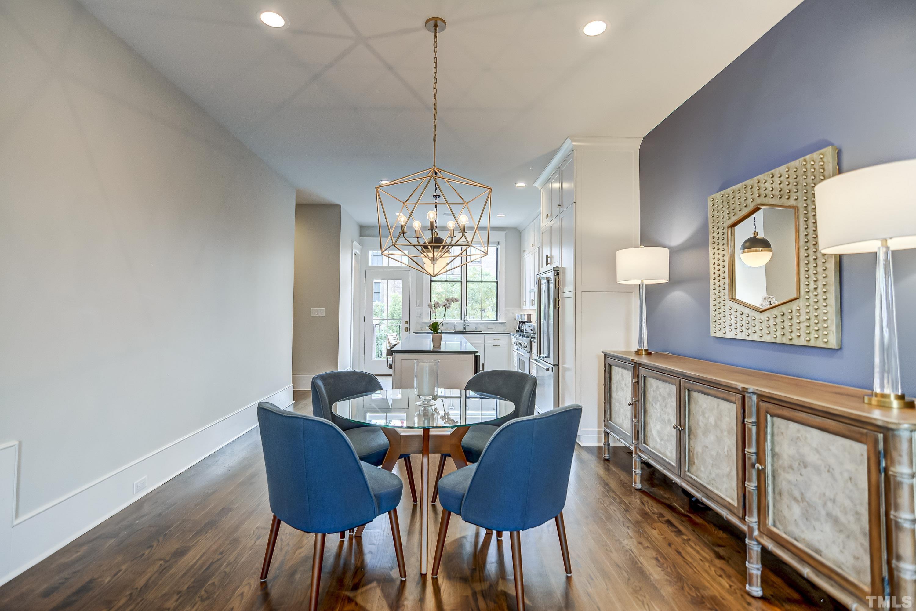 118 South East Street Raleigh, NC 27601 - Photo 11 of 40 a view of a dining room with furniture a chandelier and wooden floor