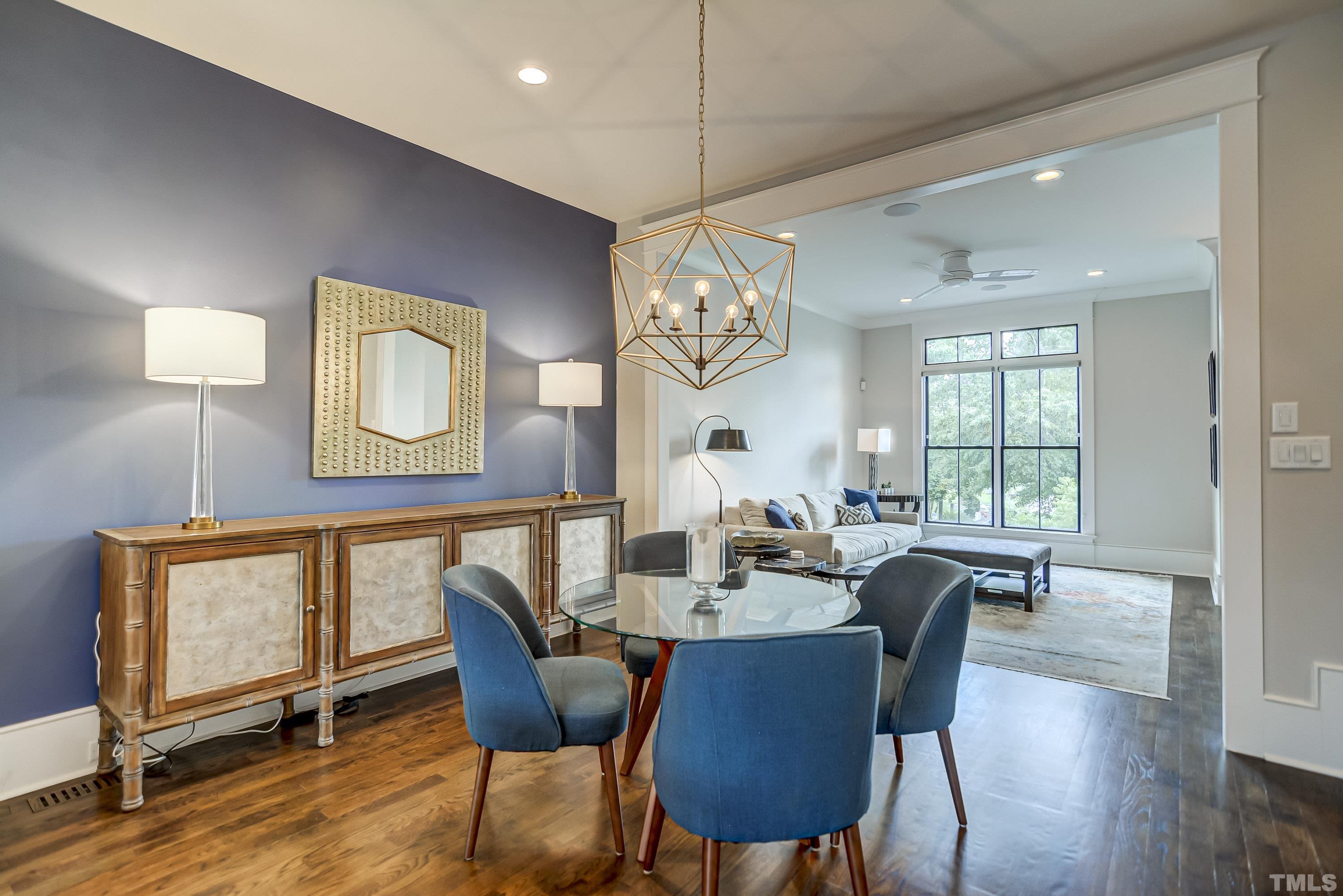 118 South East Street Raleigh, NC 27601 - Photo 12 of 40 a view of a dining room with furniture a chandelier and wooden floor