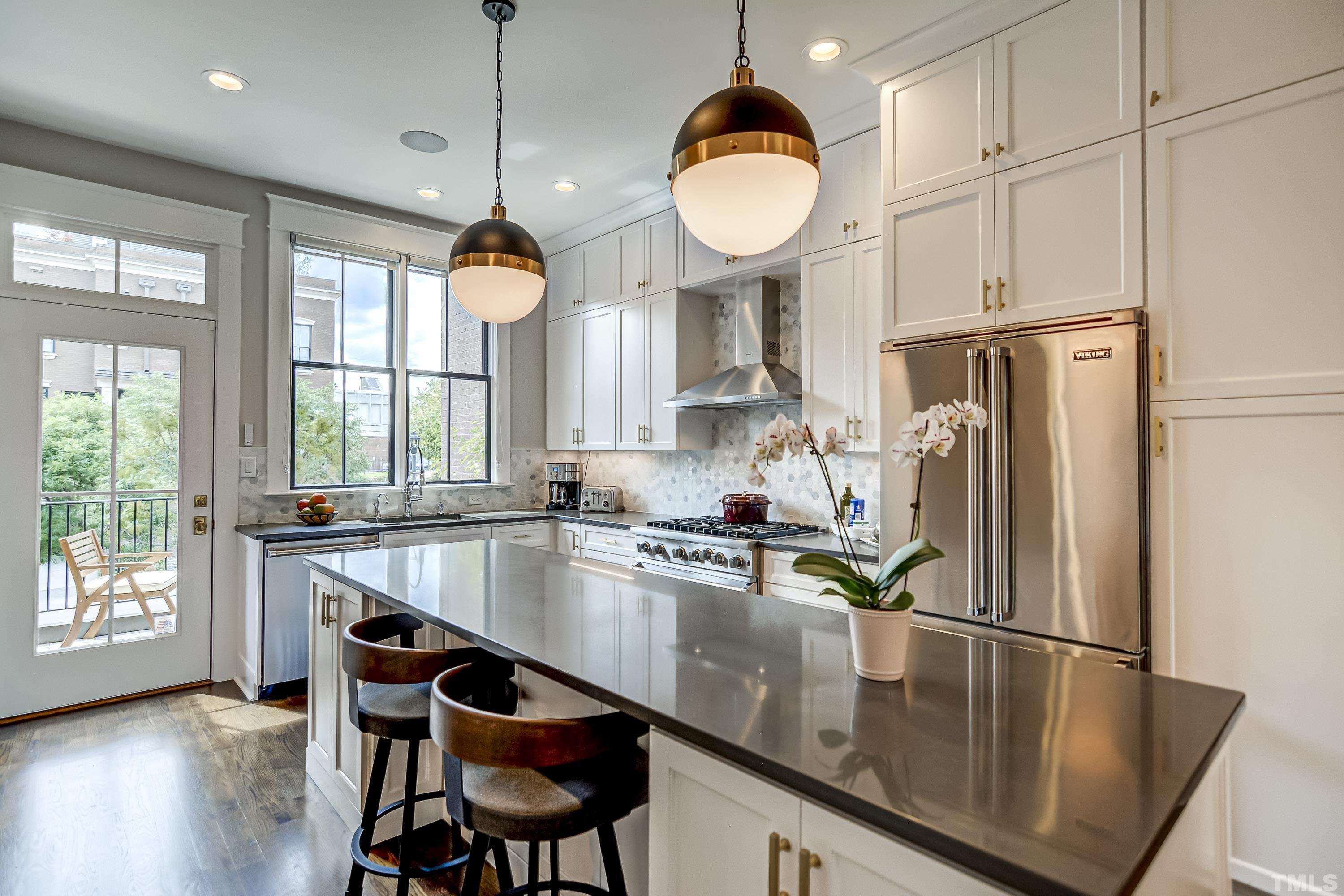 118 South East Street Raleigh, NC 27601 - Photo 13 of 40 a kitchen with stainless steel appliances granite countertop a sink a stove and a refrigerator