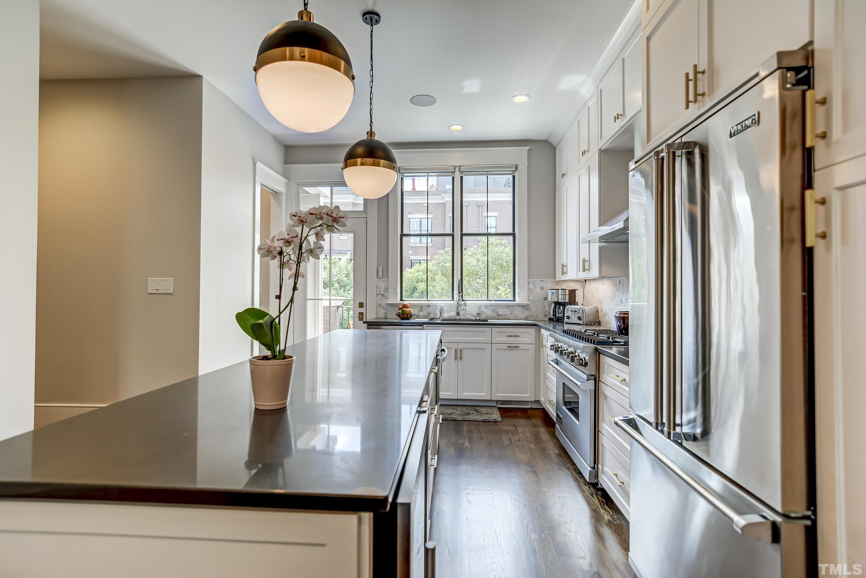 118 South East Street Raleigh, NC 27601 - Photo 14 of 40 a view of kitchen with stainless steel appliances granite countertop a stove a sink a window and dining table