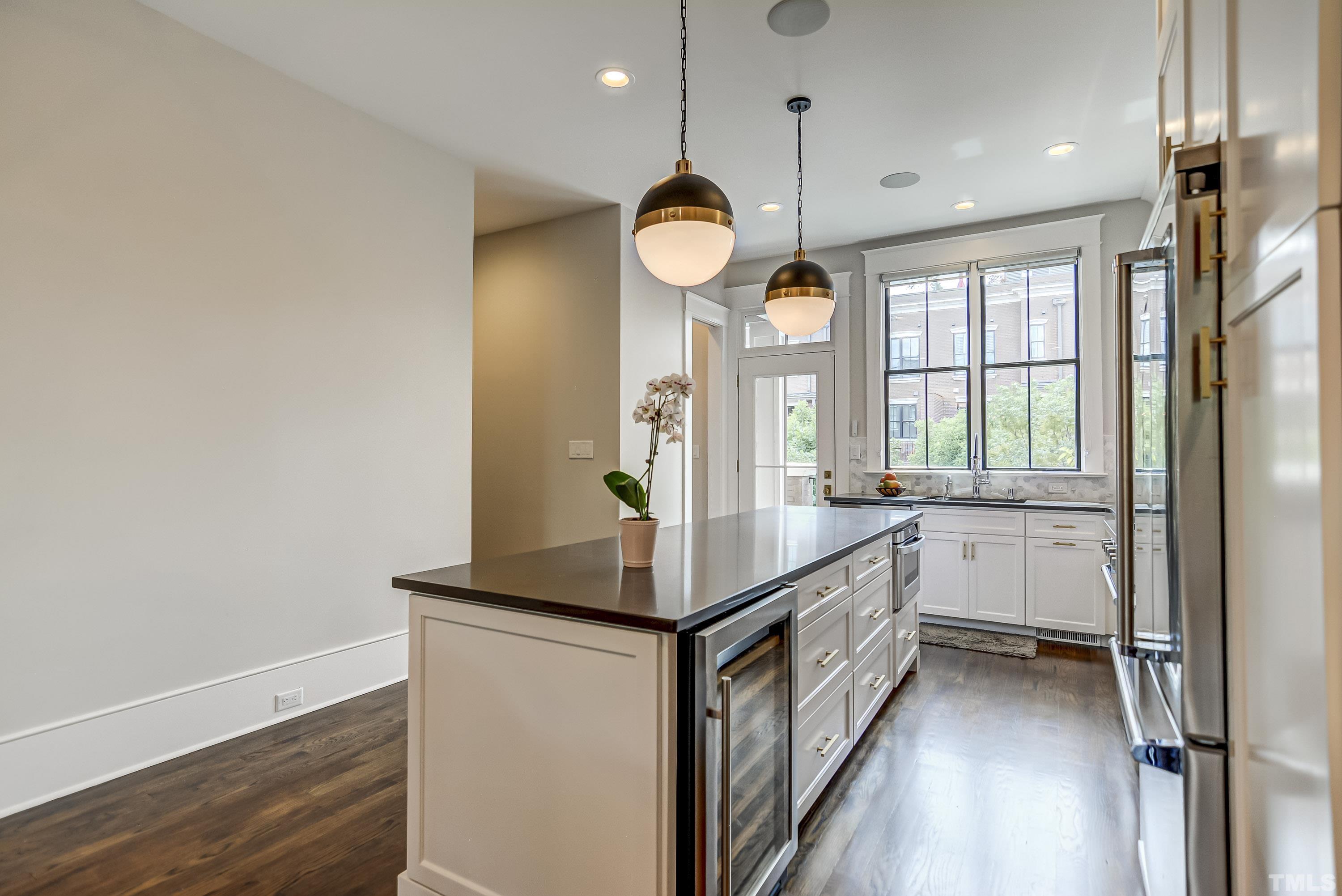 118 South East Street Raleigh, NC 27601 - Photo 15 of 40 a kitchen with kitchen island granite countertop a stove and a sink