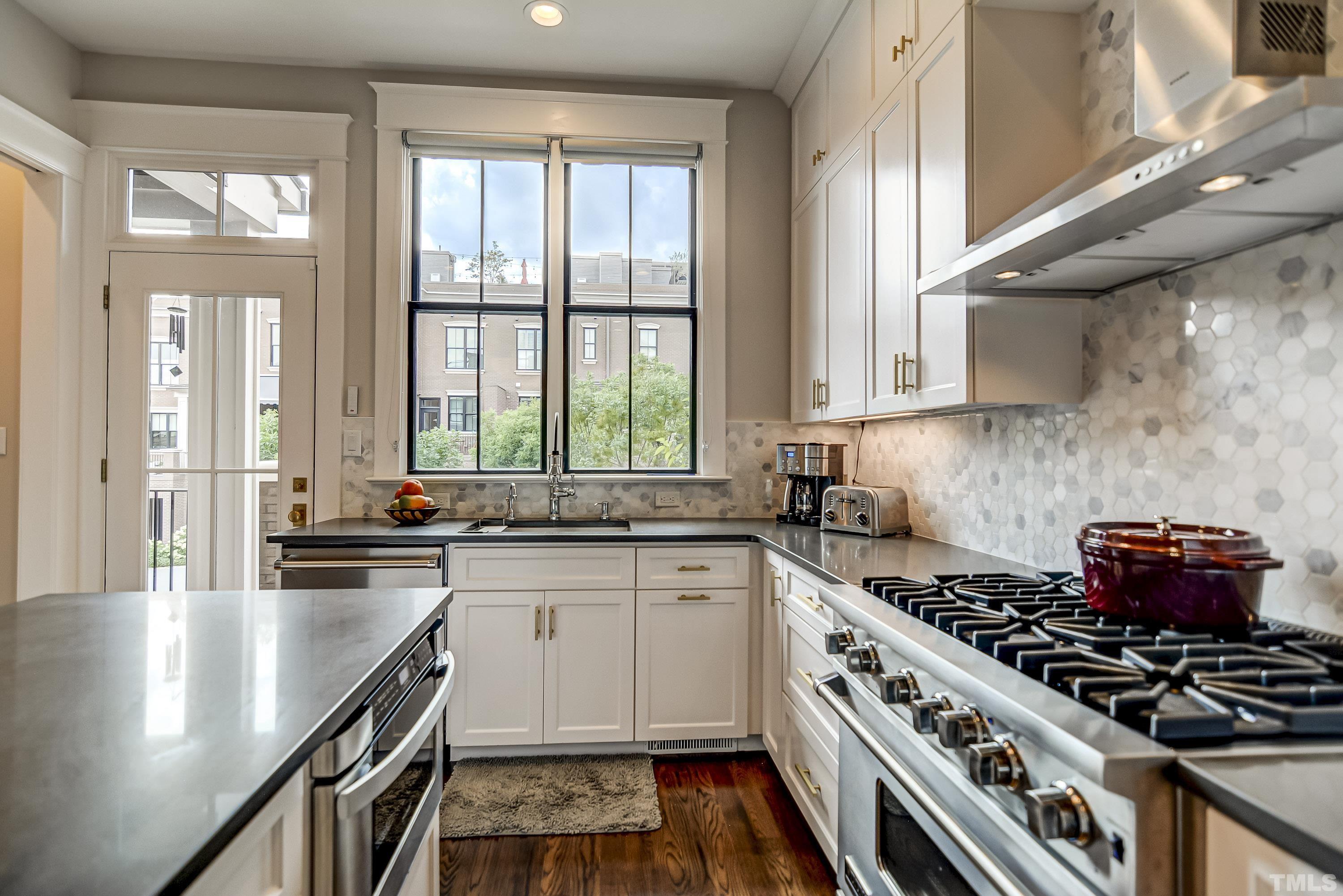 118 South East Street Raleigh, NC 27601 - Photo 16 of 40 a kitchen with a stove a sink and a window