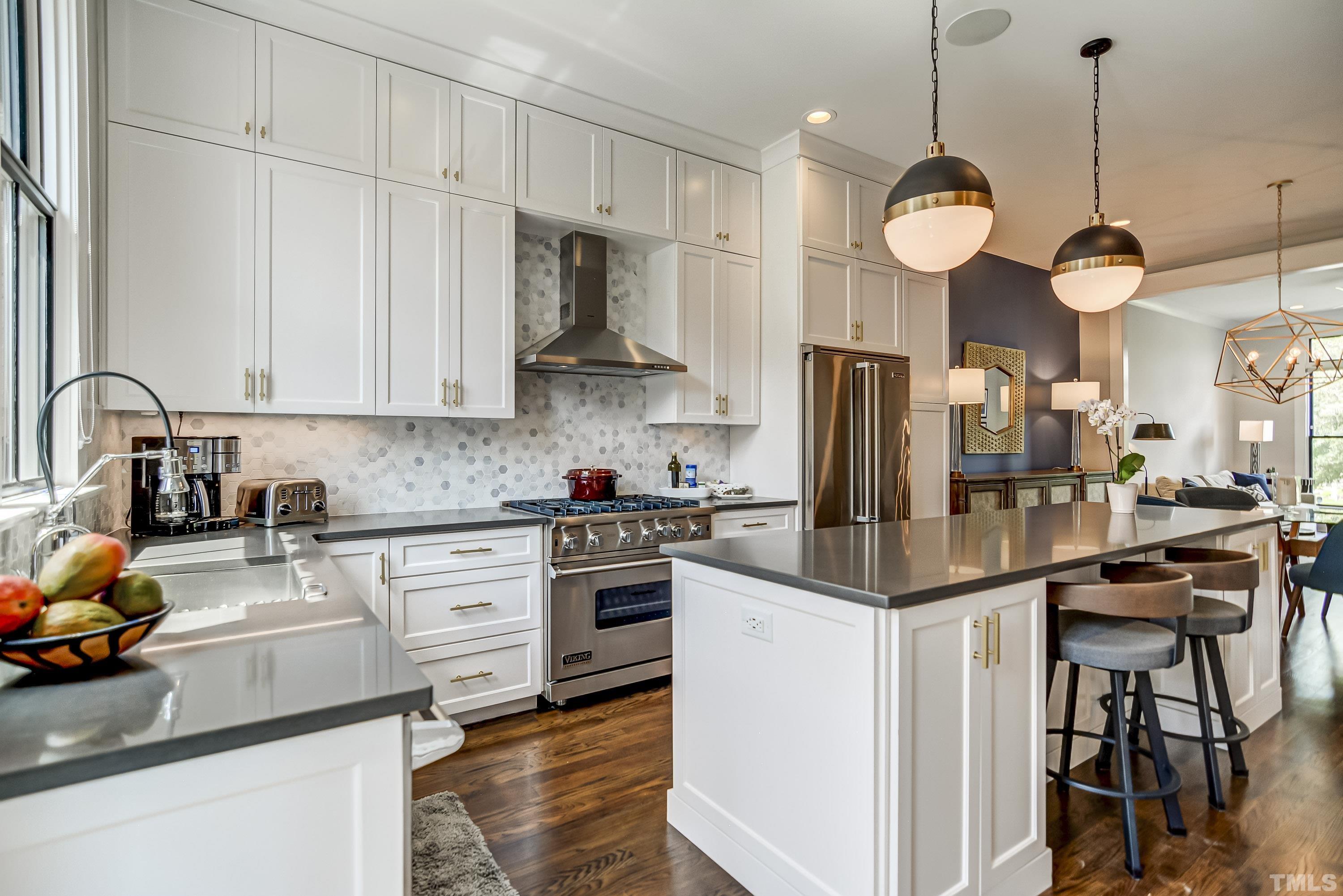 118 South East Street Raleigh, NC 27601 - Photo 17 of 40 a kitchen with stainless steel appliances granite countertop a sink a stove and a refrigerator