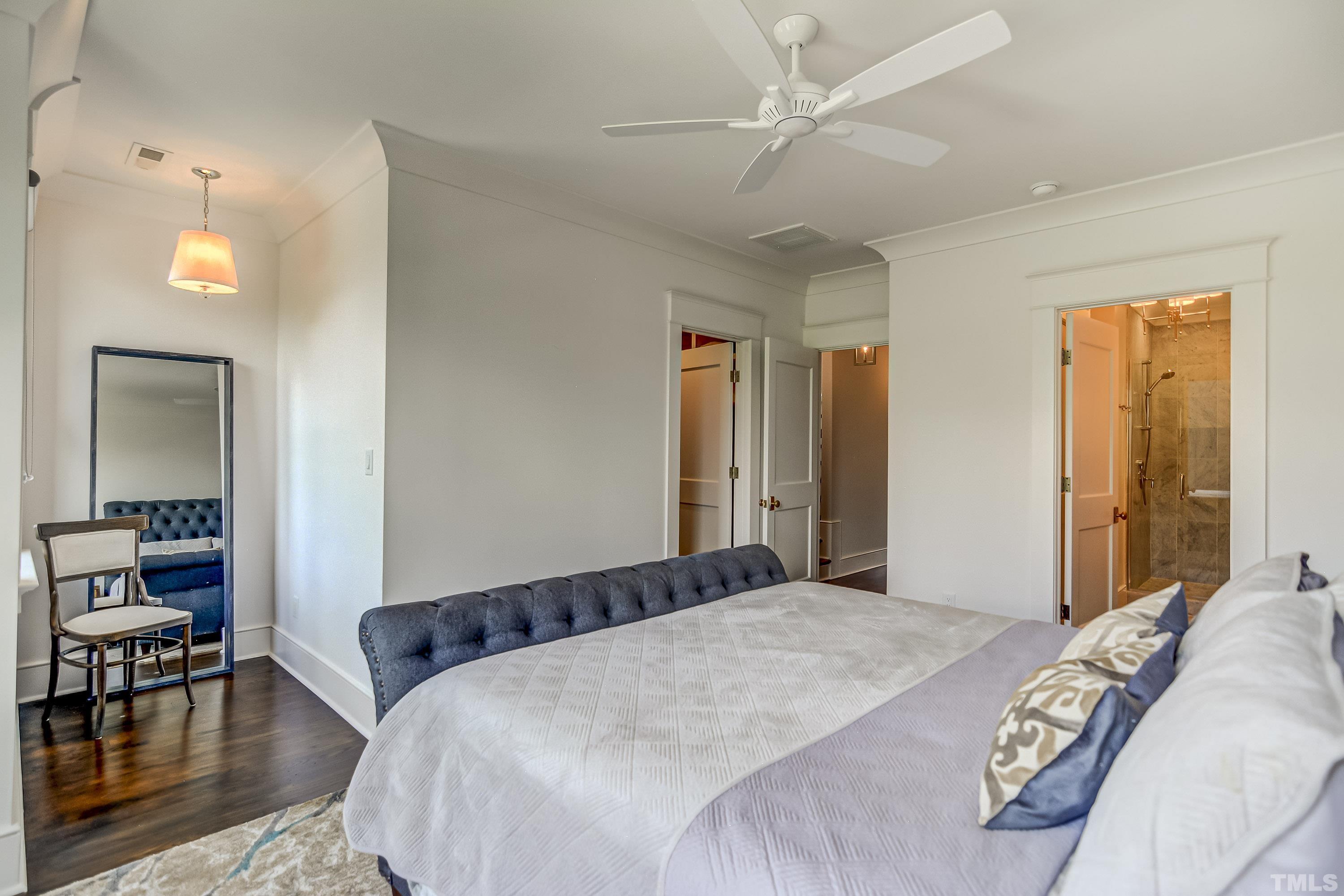 118 South East Street Raleigh, NC 27601 - Photo 20 of 40 a bedroom with a large bed and a chandelier