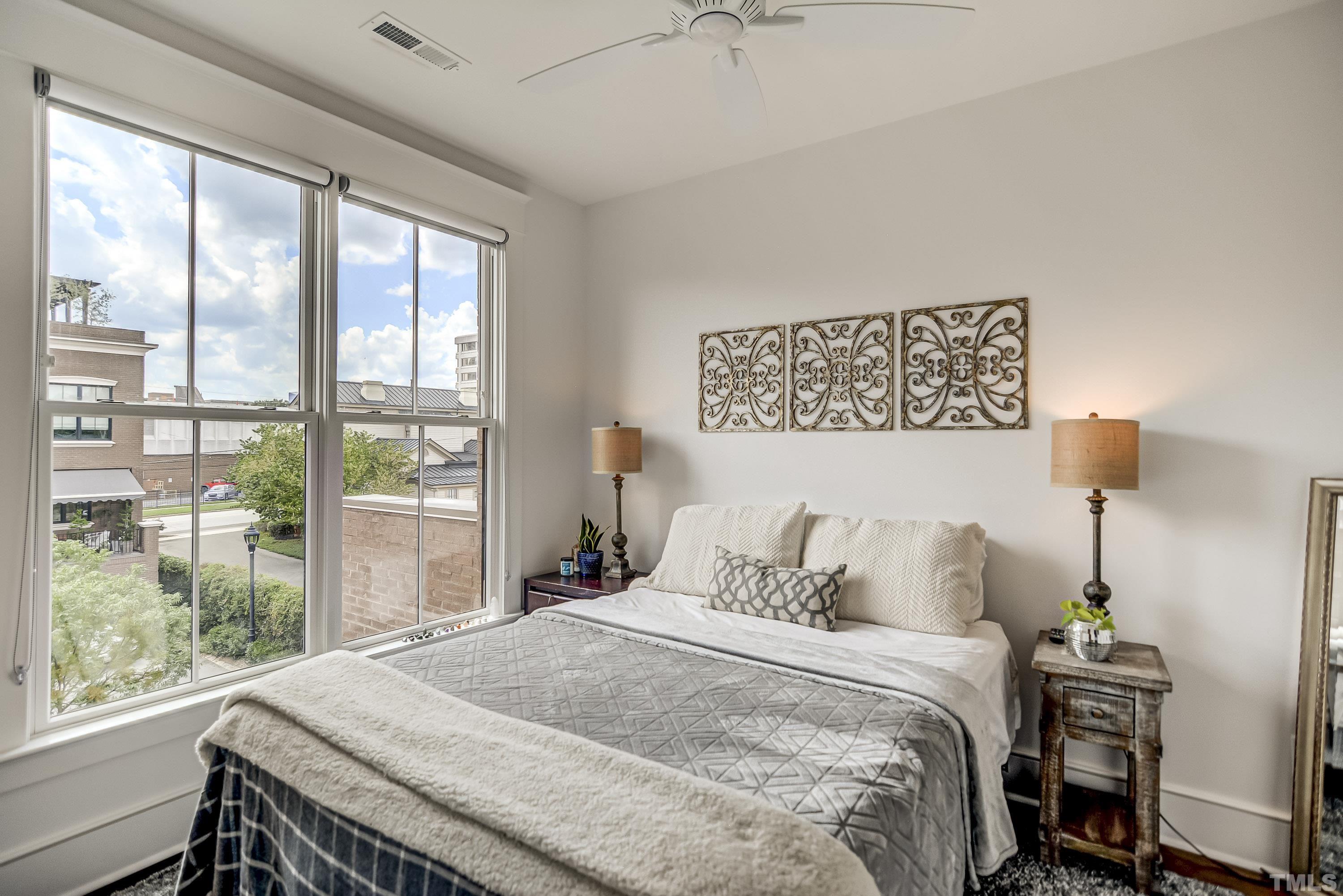 118 South East Street Raleigh, NC 27601 - Photo 23 of 40 a bedroom with a bed and a large window