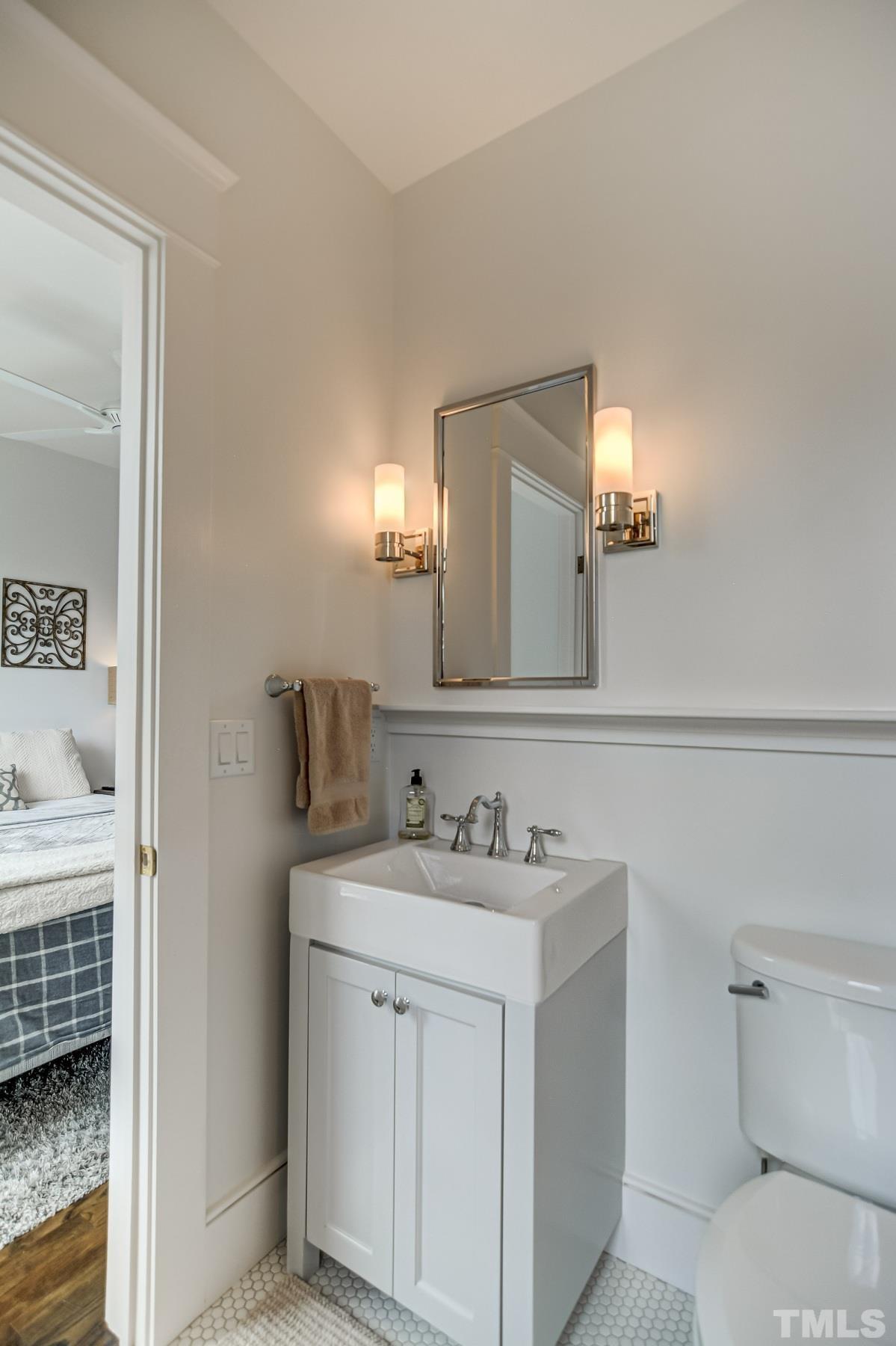 118 South East Street Raleigh, NC 27601 - Photo 24 of 40 a bathroom with a sink a toilet and a mirror