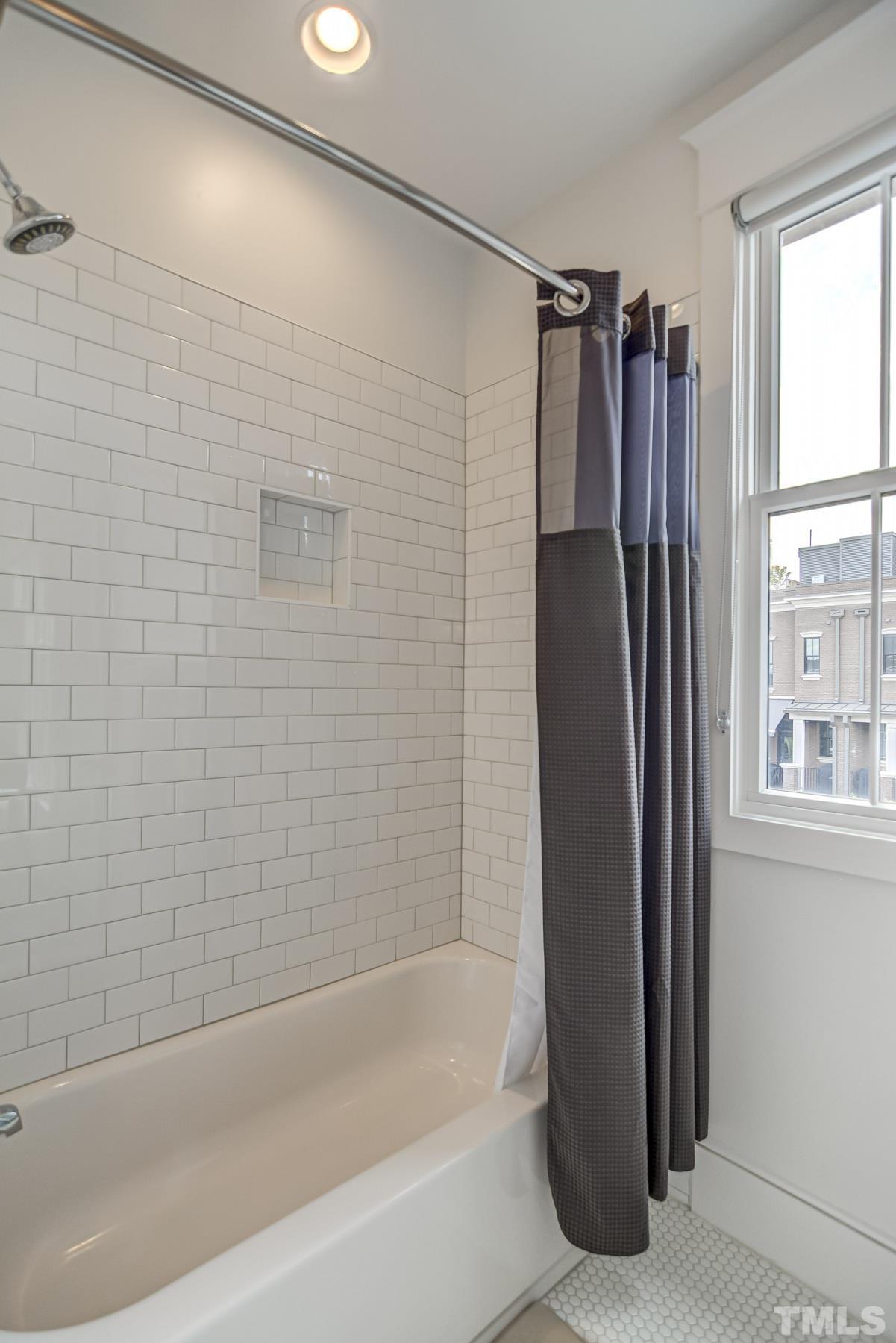 118 South East Street Raleigh, NC 27601 - Photo 25 of 40 a bathroom with a shower and a bathtub