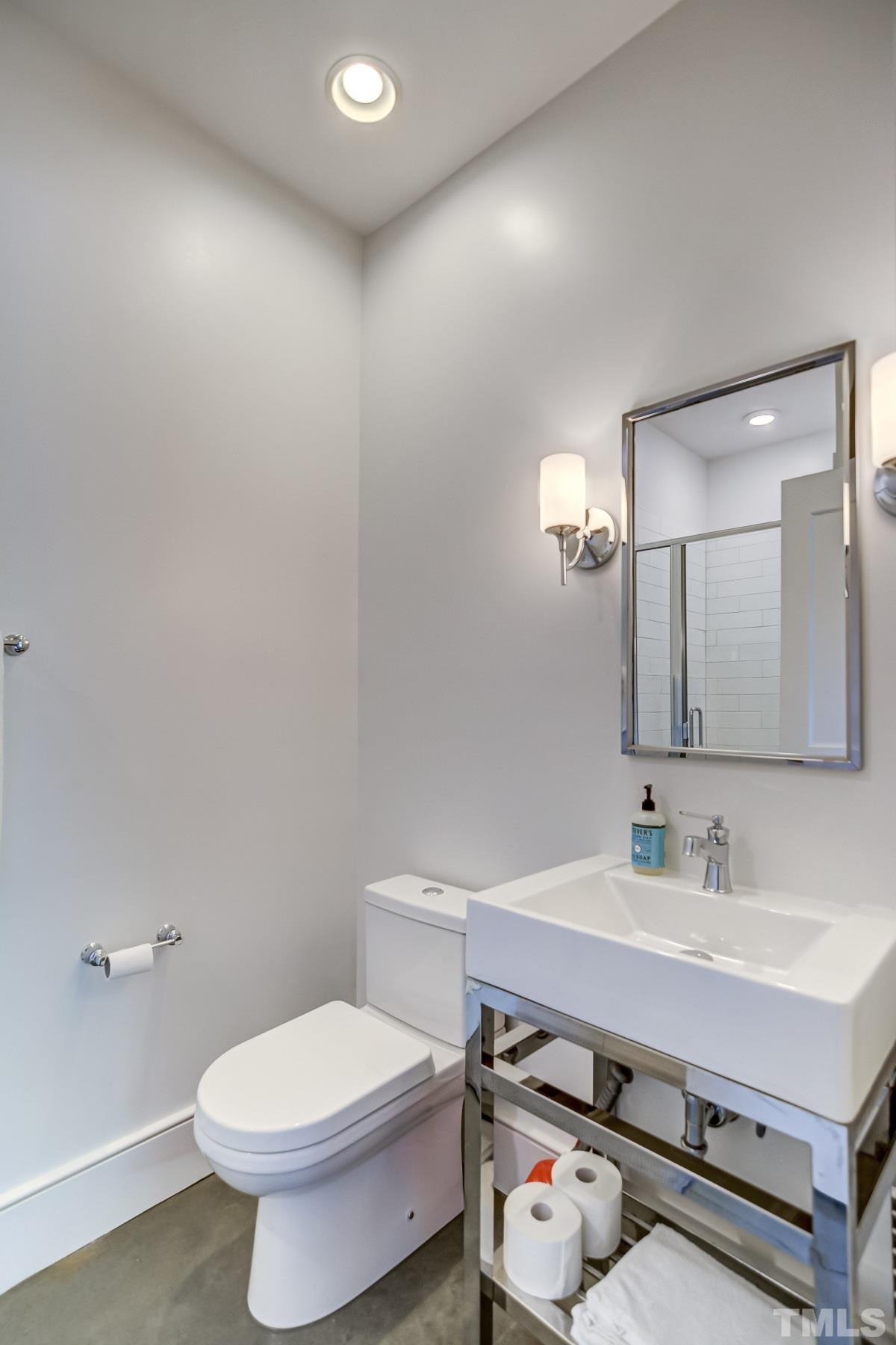 118 South East Street Raleigh, NC 27601 - Photo 29 of 40 a bathroom with a sink mirror and toilet