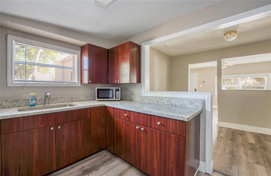 1516 East Waters Avenue Tampa, FL 33604 - Photo 11 of 25 a kitchen with a sink stove and cabinets