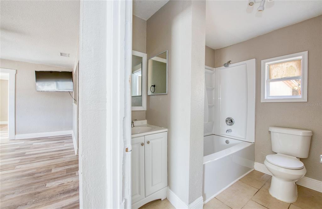 1516 East Waters Avenue Tampa, FL 33604 - Photo 16 of 25 a bathroom with a bathtub sink and toilet
