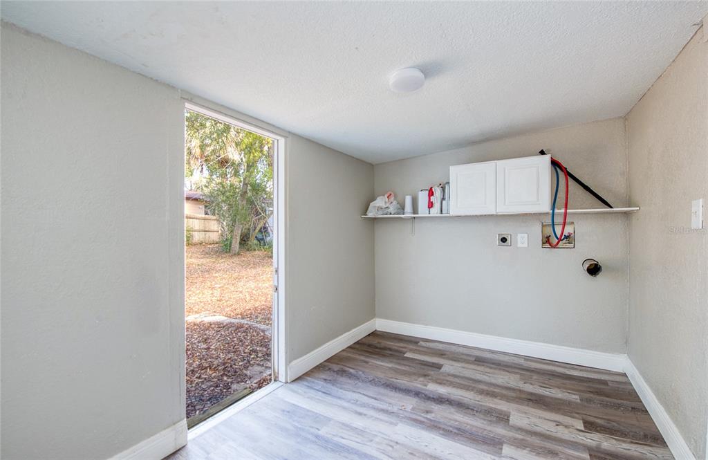1516 East Waters Avenue Tampa, FL 33604 - Photo 19 of 25 a view of an empty room with wooden floor and a window