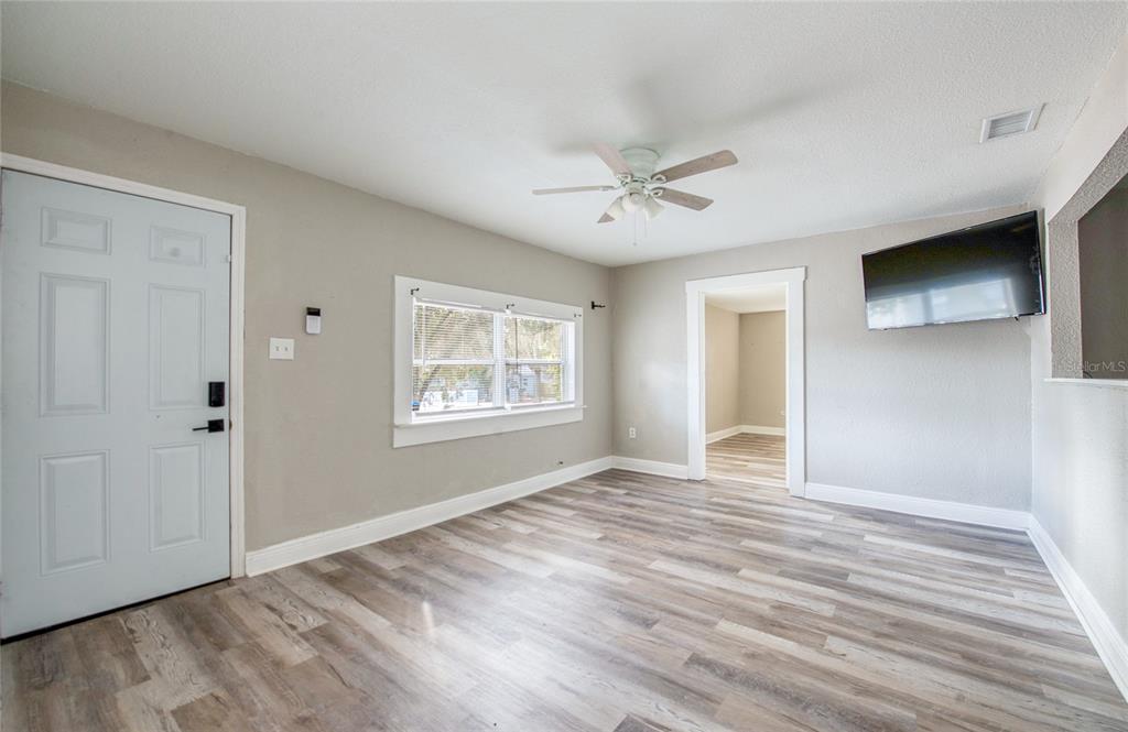 1516 East Waters Avenue Tampa, FL 33604 - Photo 3 of 25 a view of an empty room with a window and a chandelier
