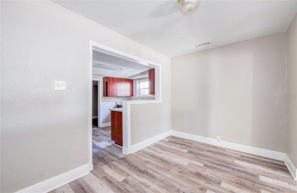 1516 East Waters Avenue Tampa, FL 33604 - Photo 8 of 25 an empty room with wooden floor and a window