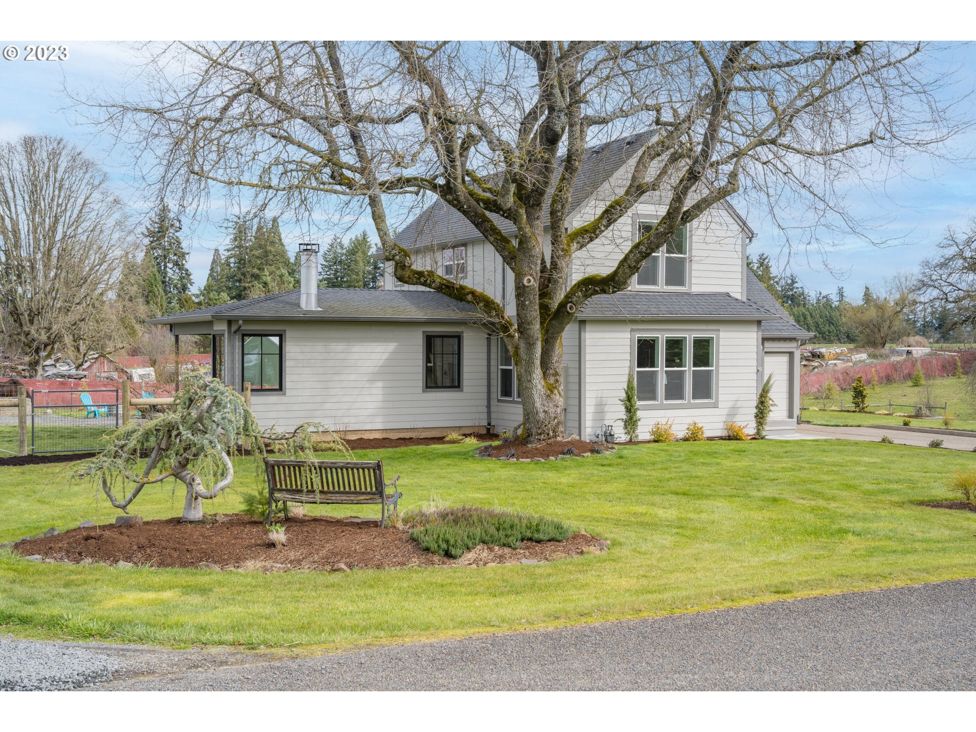 8951 South Schneider Road Canby, OR 97013 - Photo 1 of 39 a view of a yard in front of a house with a large tree