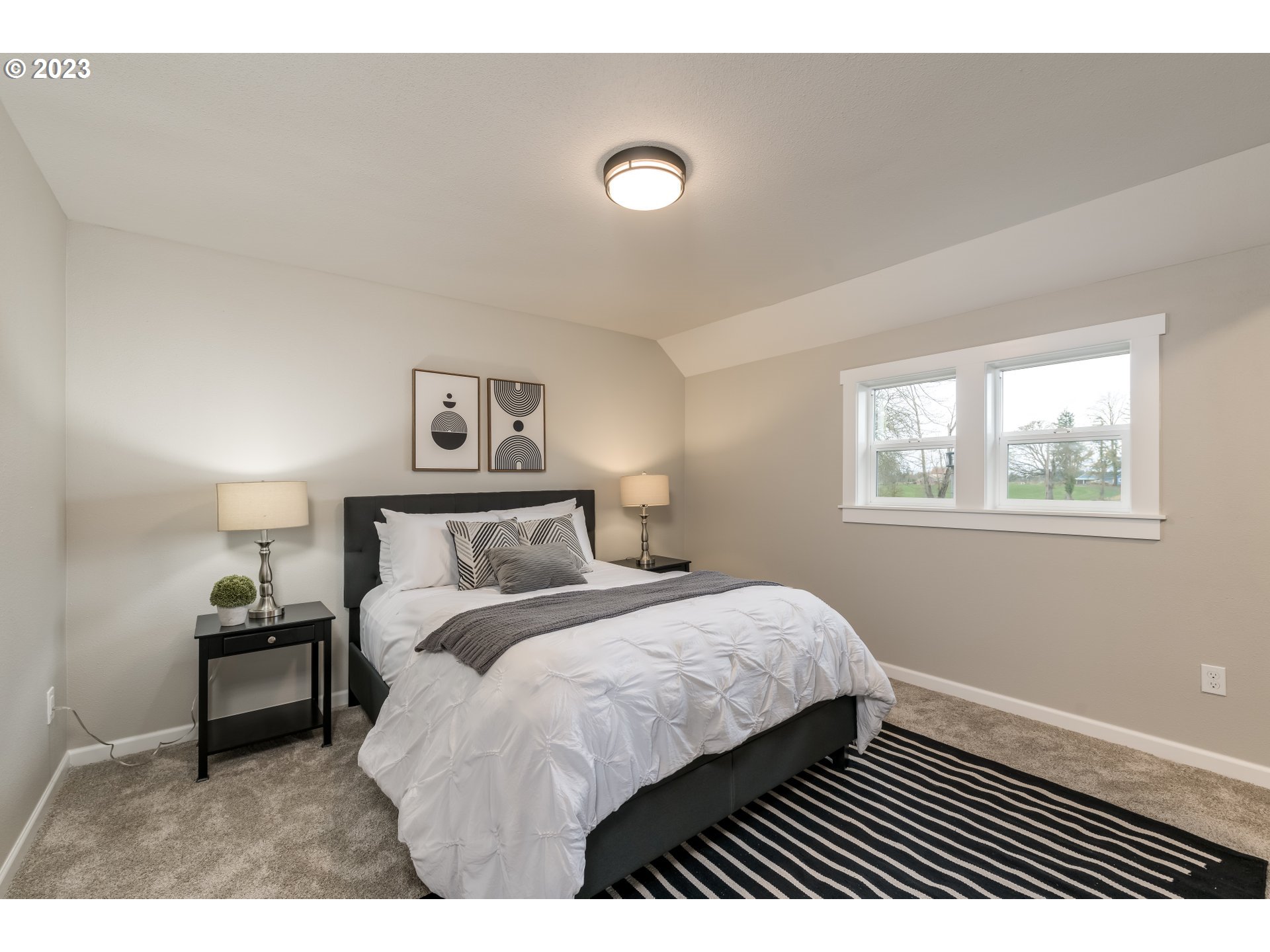 8951 South Schneider Road Canby, OR 97013 - Photo 20 of 39 a bedroom with a bed and a night stand