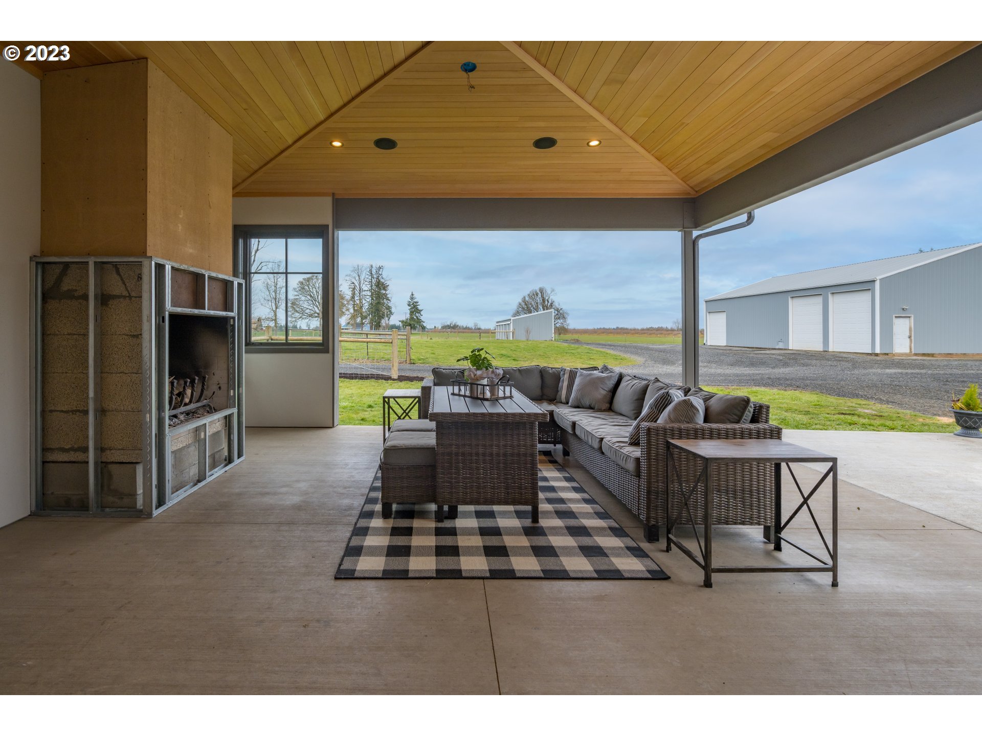 8951 South Schneider Road Canby, OR 97013 - Photo 25 of 39 a living room with furniture a flat screen tv and a floor