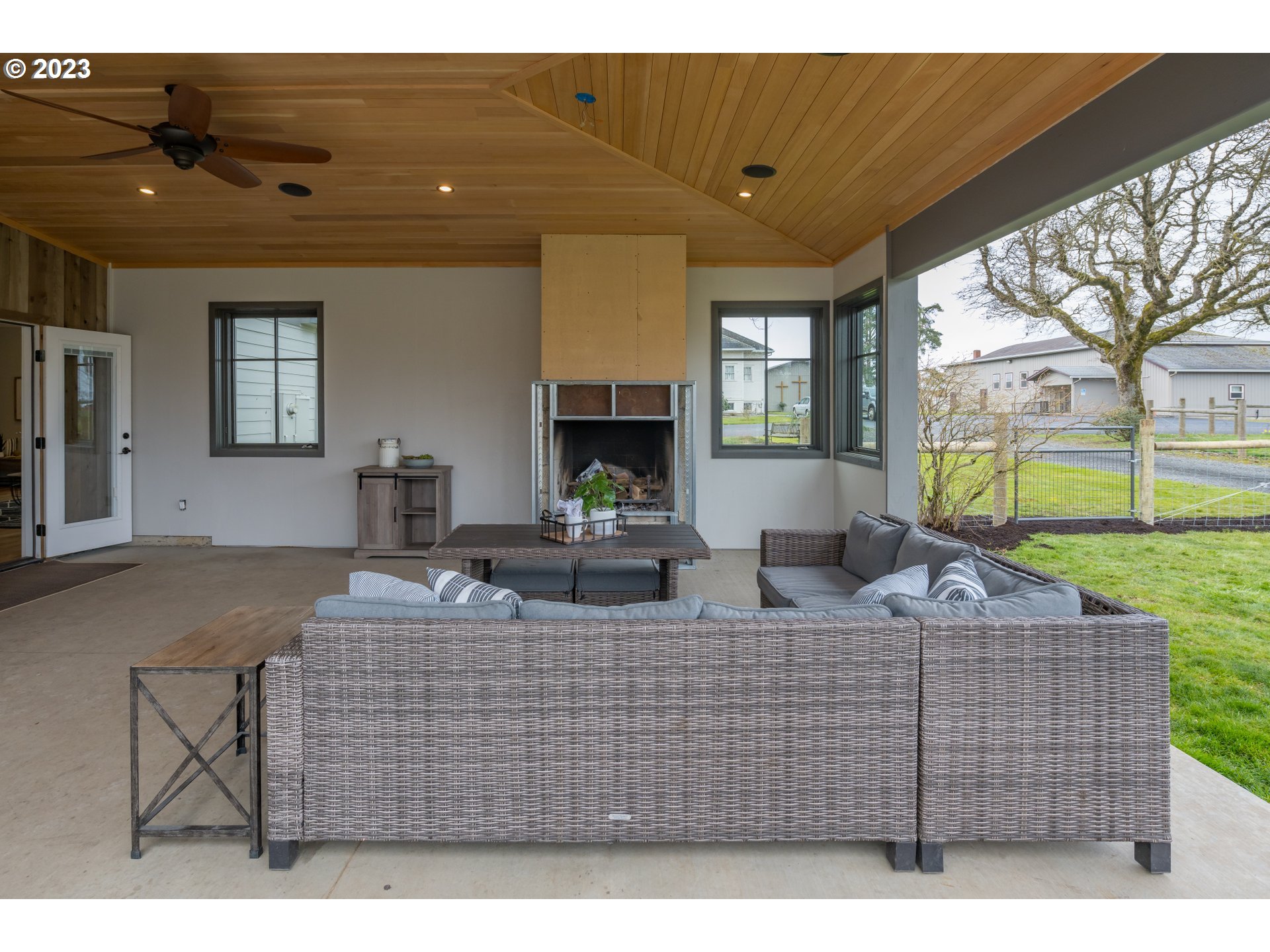 8951 South Schneider Road Canby, OR 97013 - Photo 26 of 39 a living room with furniture a large window and a fireplace