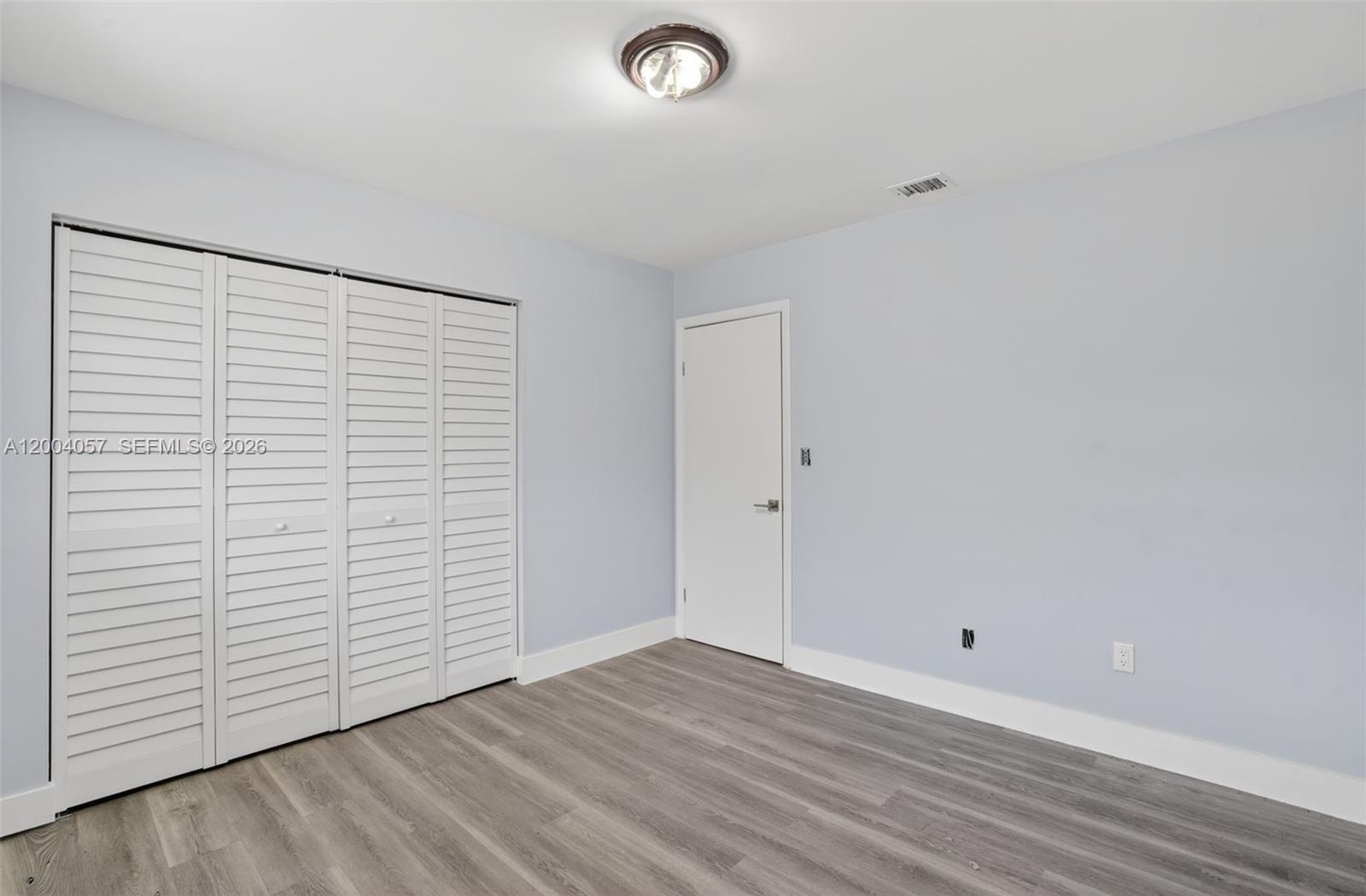 2276 West 56th Street, Unit 109 Hialeah, FL 33016 - Photo 13 of 22 wooden floor in an empty room