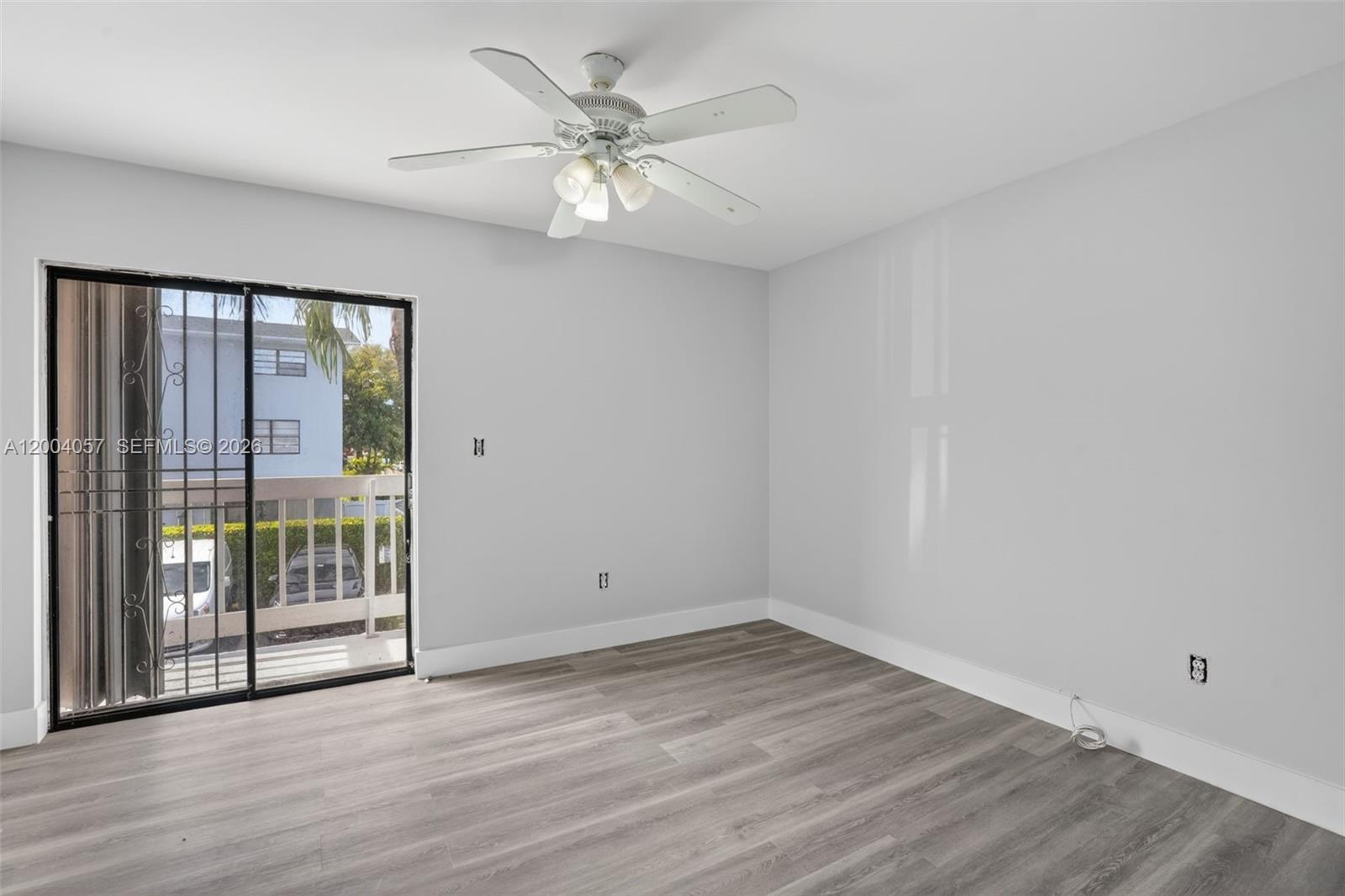 2276 West 56th Street, Unit 109 Hialeah, FL 33016 - Photo 16 of 22 wooden floor in an empty room with a window
