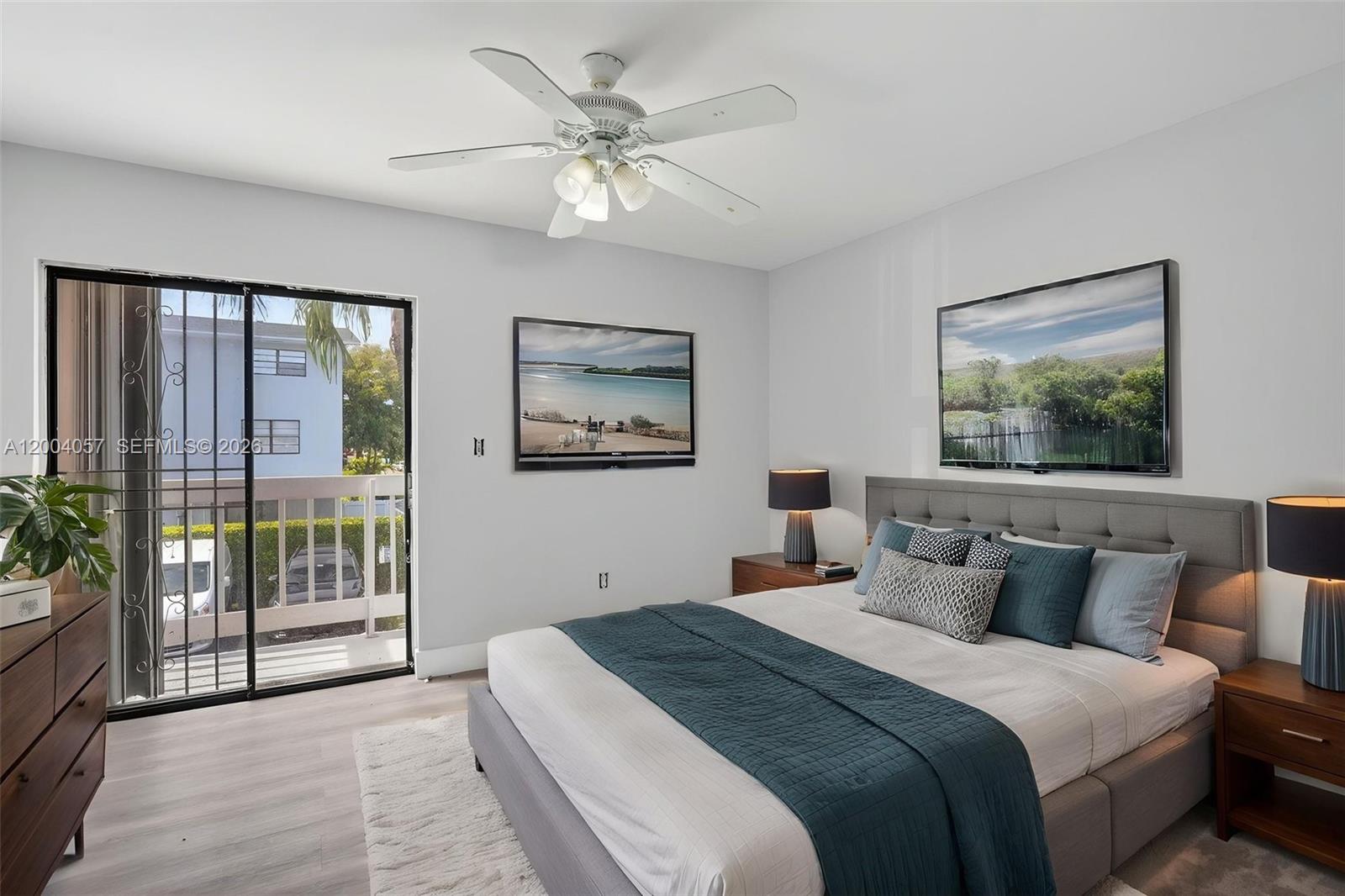 2276 West 56th Street, Unit 109 Hialeah, FL 33016 - Photo 17 of 22 a bedroom with a large bed and a chandelier