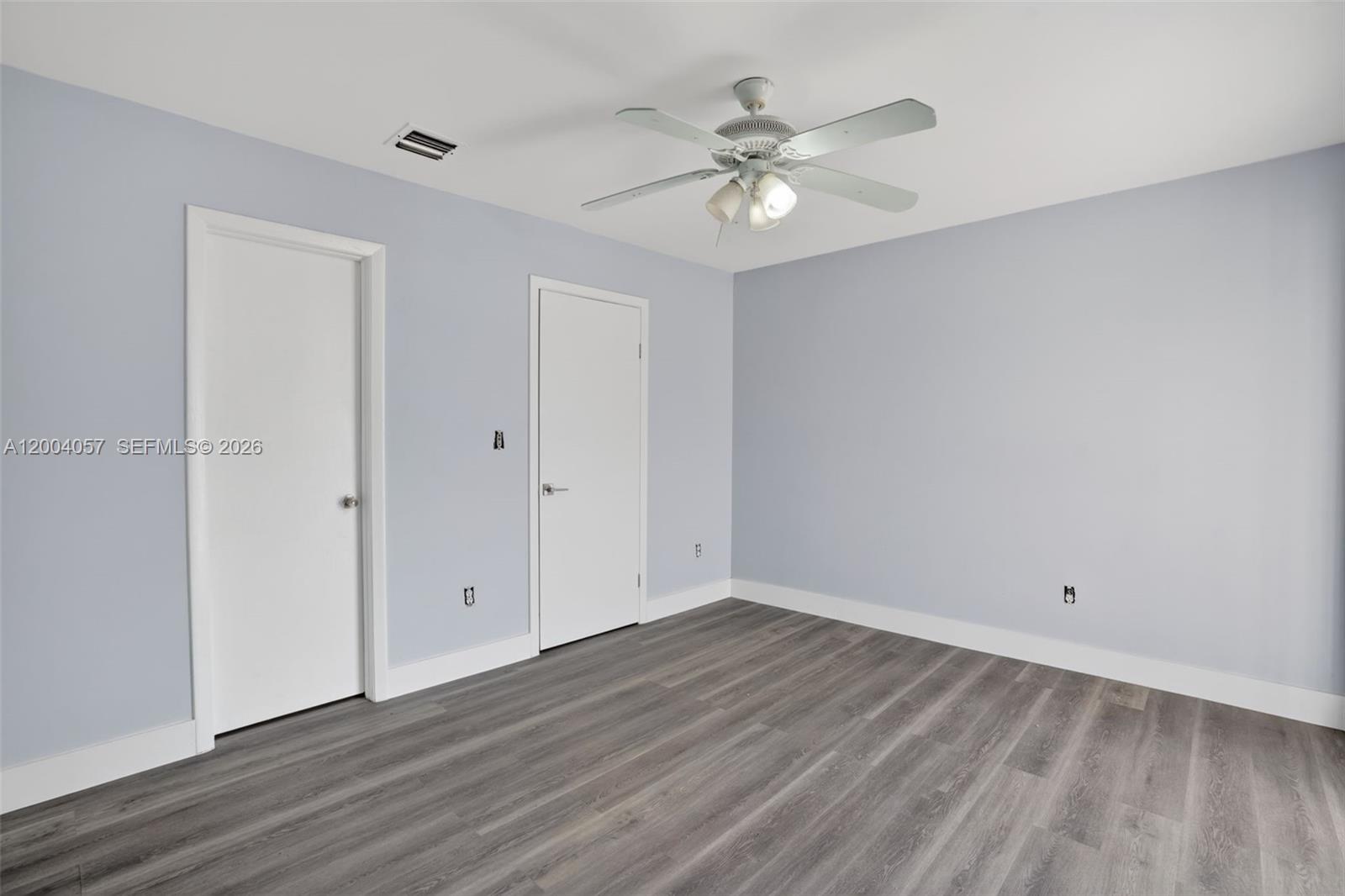 2276 West 56th Street, Unit 109 Hialeah, FL 33016 - Photo 18 of 22 a view of an empty room with wooden floor