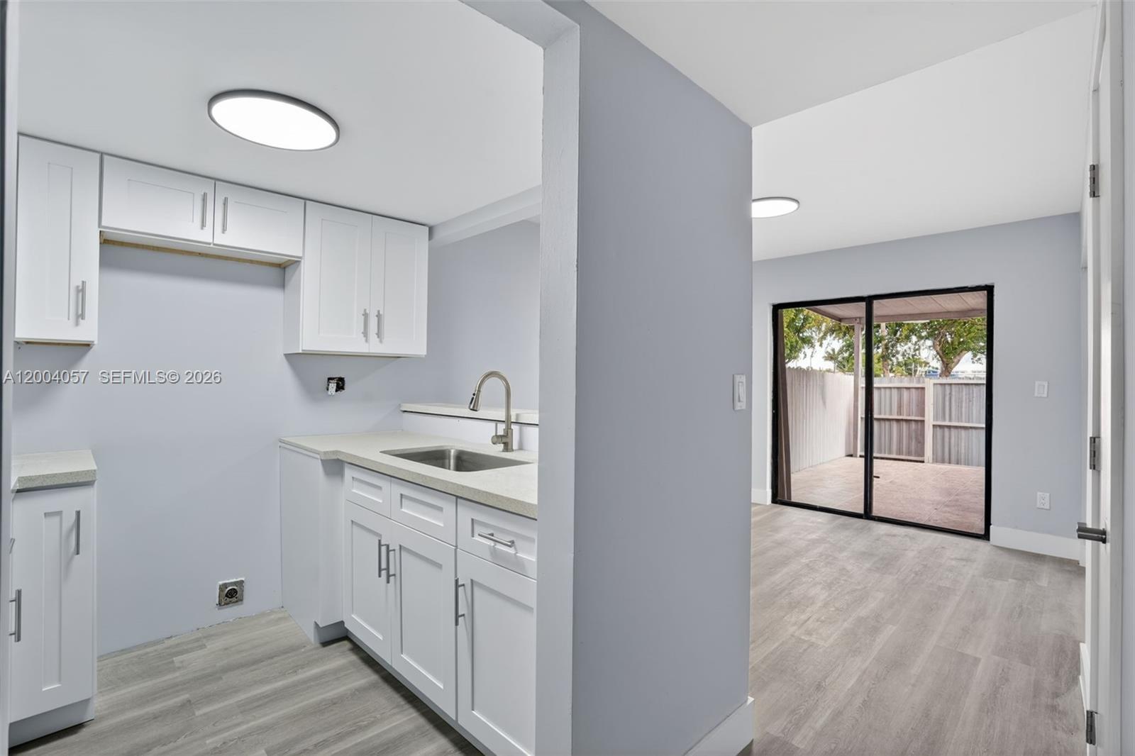 2276 West 56th Street, Unit 109 Hialeah, FL 33016 - Photo 4 of 22 a kitchen with a sink cabinets and window