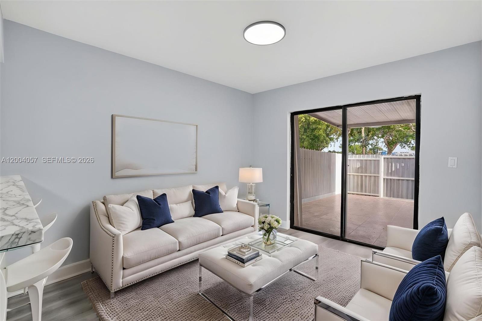 2276 West 56th Street, Unit 109 Hialeah, FL 33016 - Photo 7 of 22 a living room with furniture and a large window