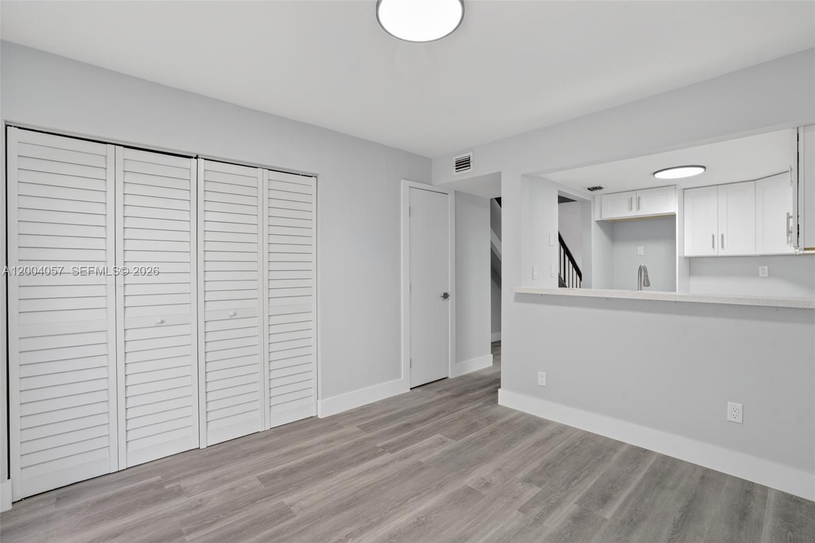 2276 West 56th Street, Unit 109 Hialeah, FL 33016 - Photo 8 of 22 a view of empty room with wooden floor