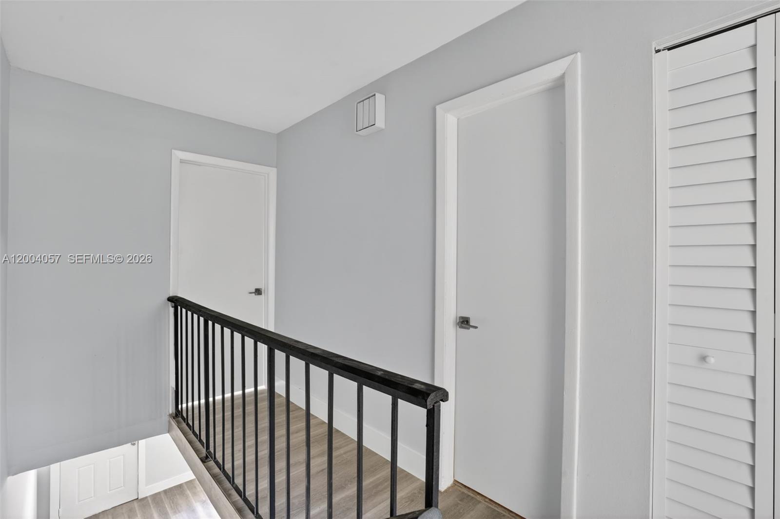 2276 West 56th Street, Unit 109 Hialeah, FL 33016 - Photo 10 of 22 a view of a hallway with wooden floor and entryway