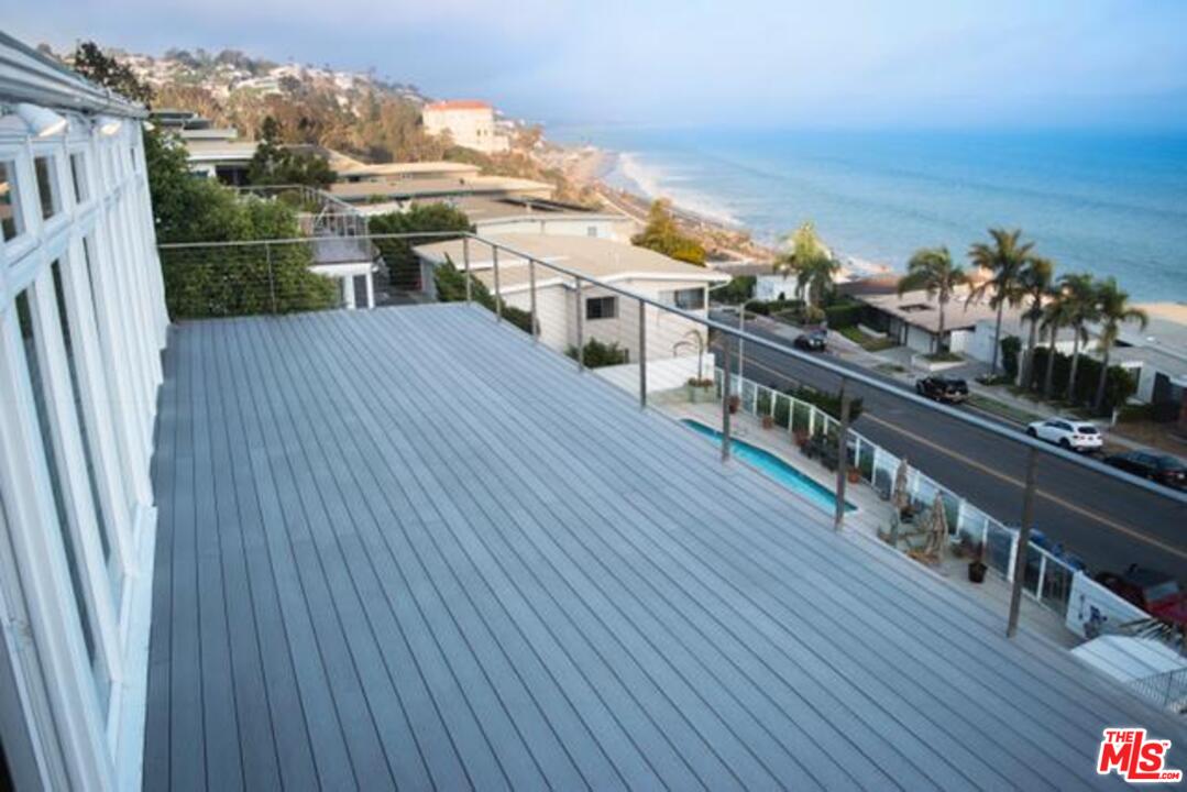 18125 Coastline Drive, Unit A Malibu, CA 90265 - Photo 7 of 9 a view of a balcony with wooden floor