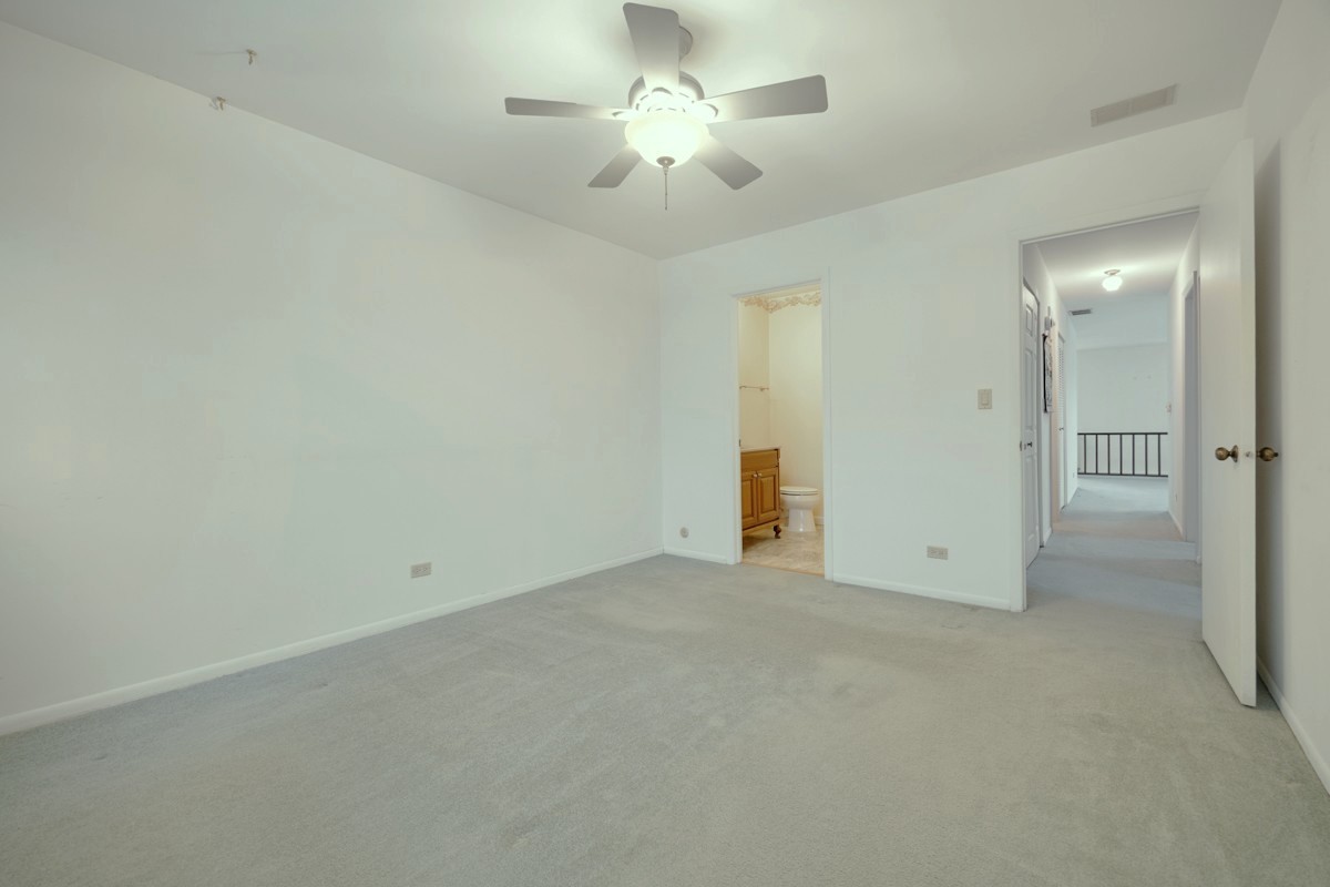 784 Leicester Road Elk Grove Village, IL 60007 - Photo 14 of 27 an empty room with chandelier fan and closet area