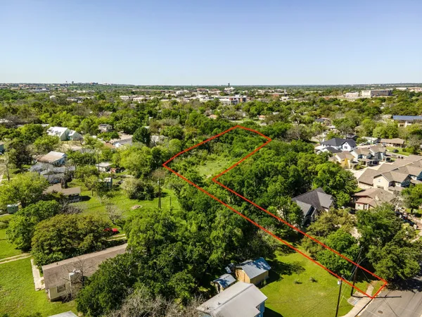 an aerial view of residential houses with city view