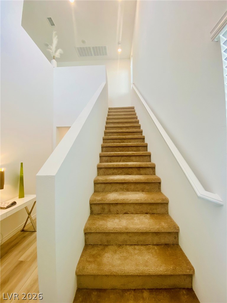 4457 Sawyer Ridge Street Las Vegas, NV 89147 - Photo 18 of 32 Ascend to comfort with this inviting carpeted staircase.