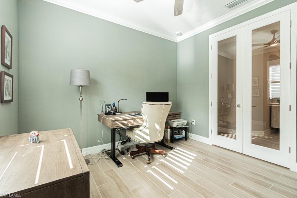 1869 Mustique Street Naples, FL 34120 - Photo 15 of 48 a view of a workspace with furniture and wooden floor