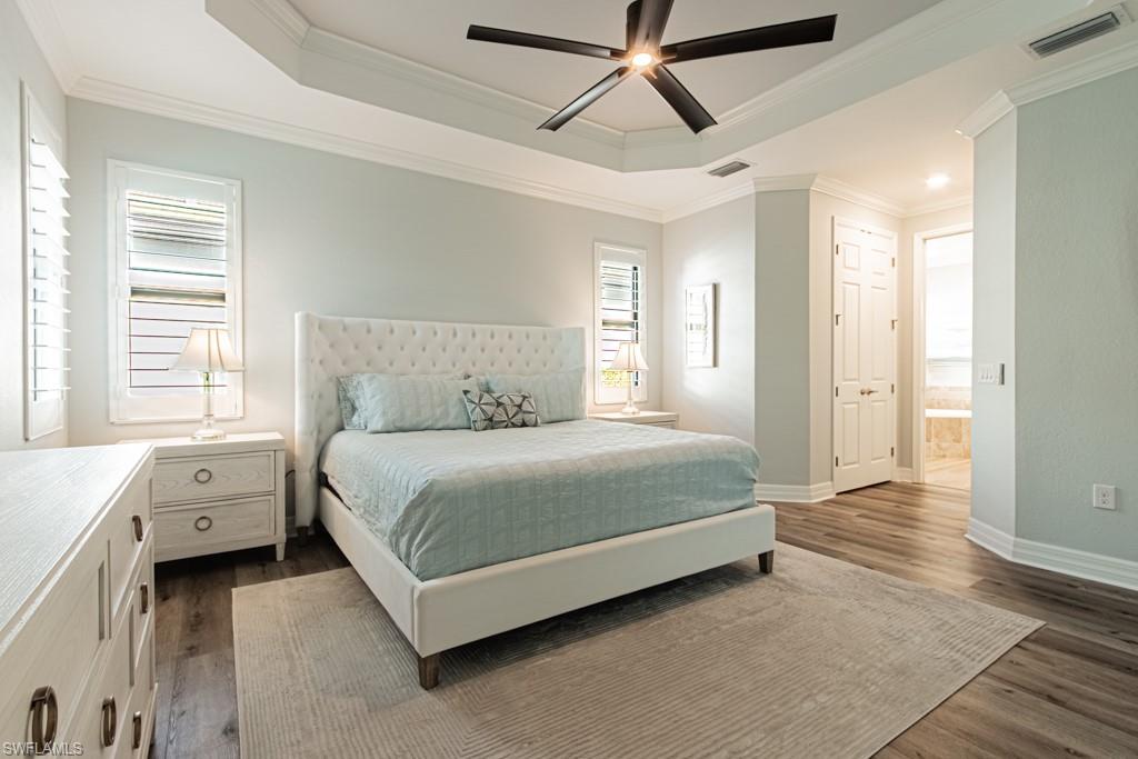 1869 Mustique Street Naples, FL 34120 - Photo 17 of 48 a spacious bedroom with a bed and a window