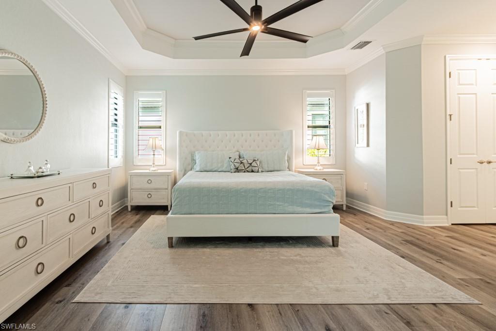 1869 Mustique Street Naples, FL 34120 - Photo 18 of 48 a bedroom with a large bed and a window
