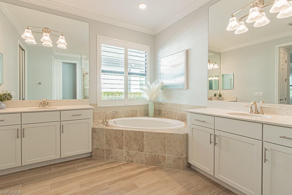1869 Mustique Street Naples, FL 34120 - Photo 20 of 48 a spacious bathroom with a double vanity sink mirror and bathtub