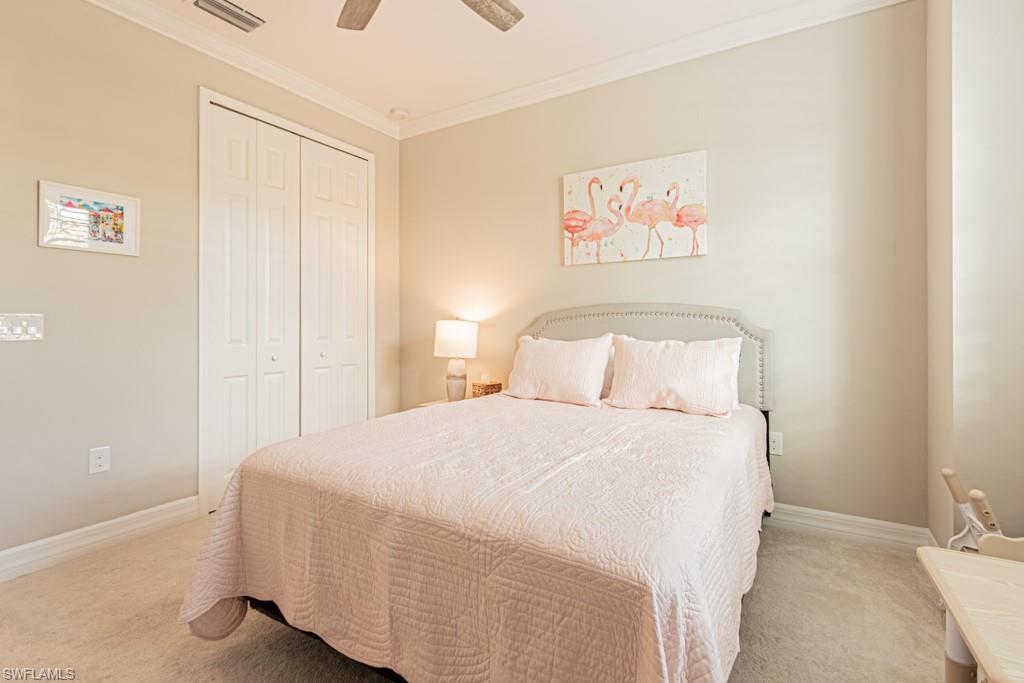 1869 Mustique Street Naples, FL 34120 - Photo 22 of 48 a bedroom with a bed and a painting on the wall
