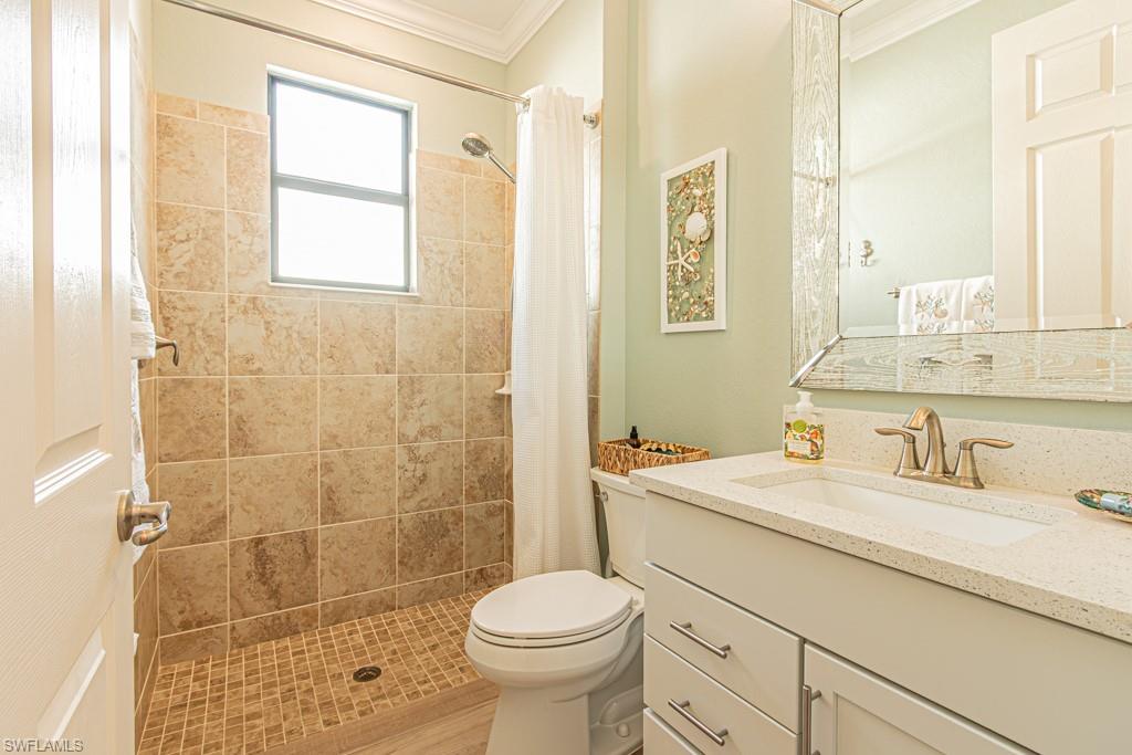1869 Mustique Street Naples, FL 34120 - Photo 23 of 48 a bathroom with a sink toilet and shower