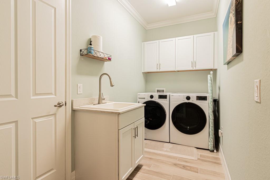 1869 Mustique Street Naples, FL 34120 - Photo 24 of 48 a utility room with sink dryer and washer