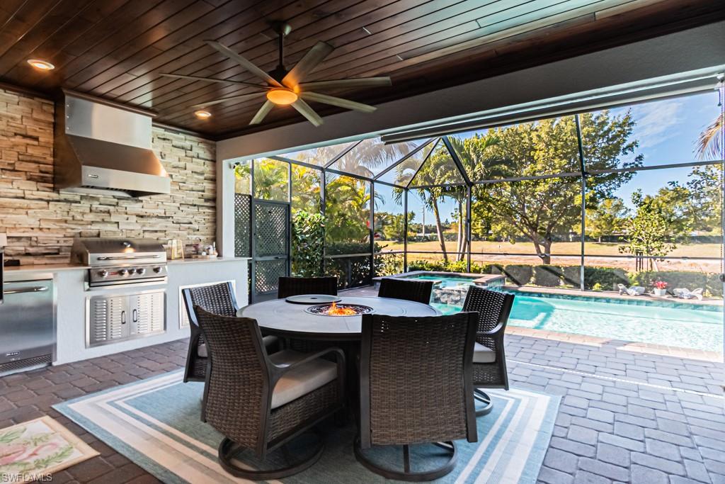 1869 Mustique Street Naples, FL 34120 - Photo 26 of 48 a dining room with furniture and a floor to ceiling window