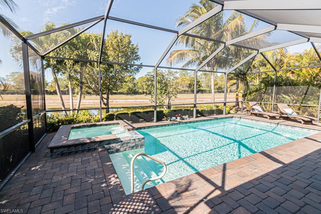 1869 Mustique Street Naples, FL 34120 - Photo 27 of 48 a view of a swimming pool with a yard