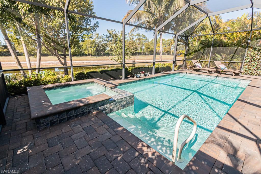 1869 Mustique Street Naples, FL 34120 - Photo 28 of 48 a view of a swimming pool with a patio
